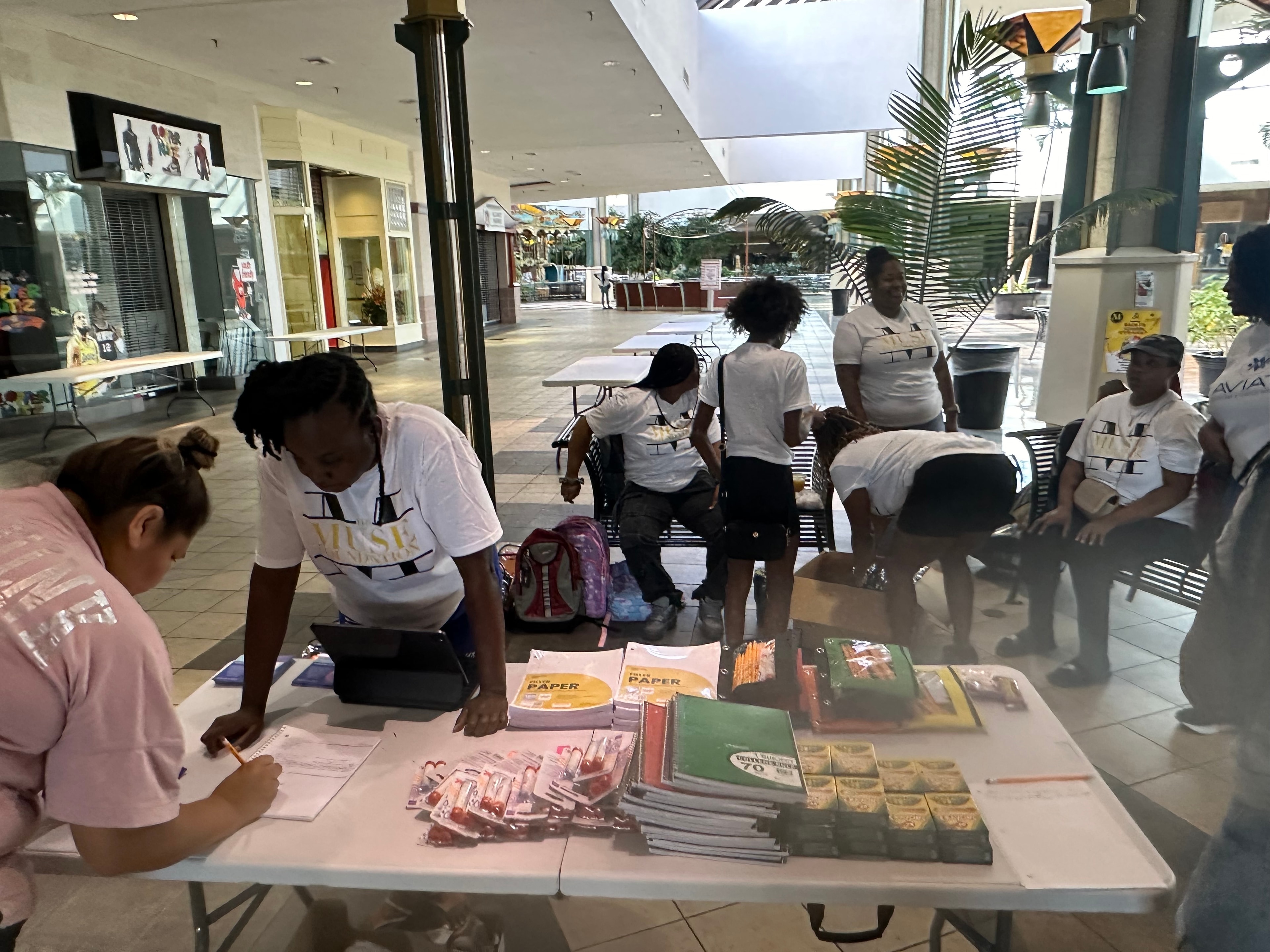 Muse Foundation volunteer registering a community member at the backpack giveaway