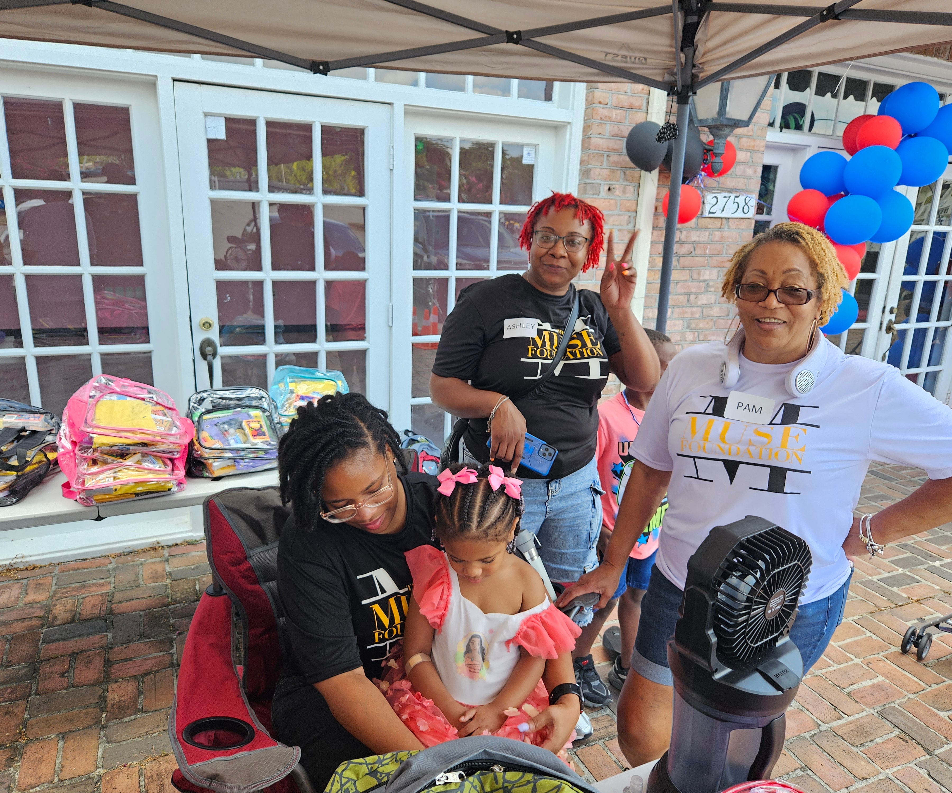 Muse Foundation volunteers preparing school supplies at the event table